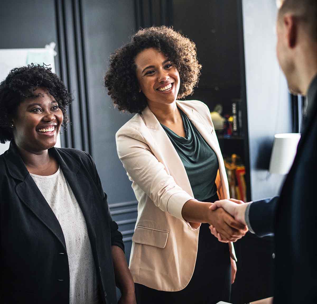 Business woman shaking hands with man